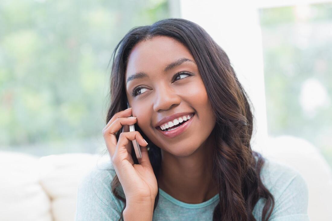 woman smiling talking on the phone 
