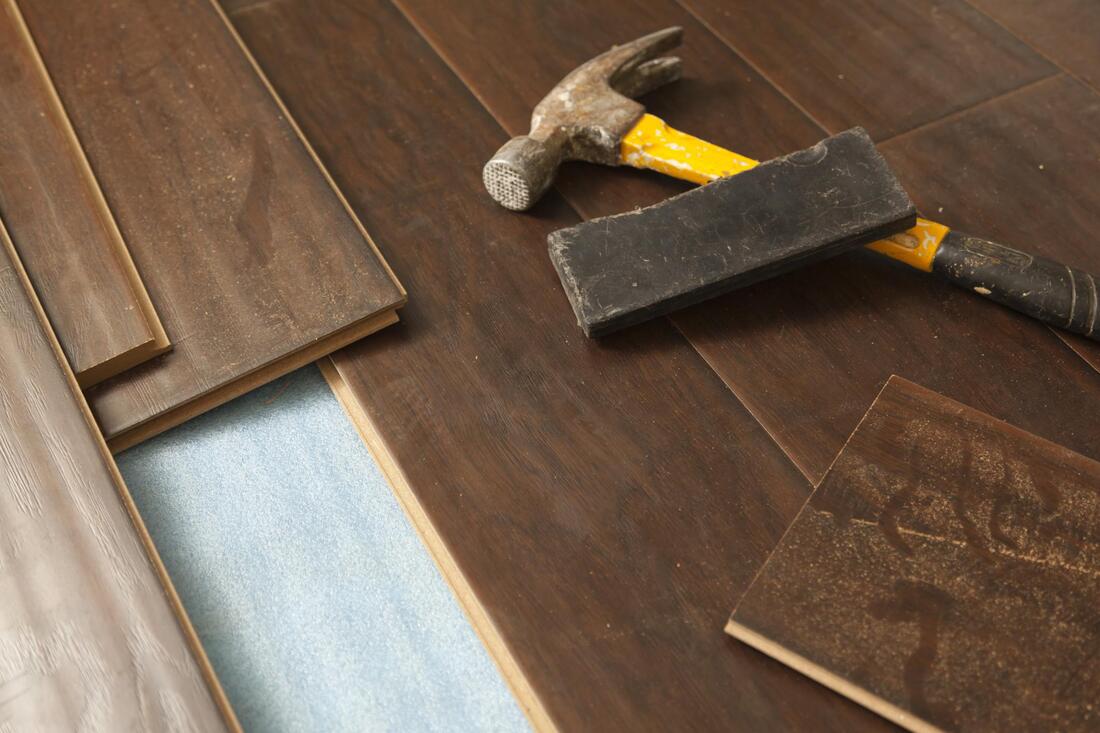 professional hardwood expert working on hardwood floor repair 